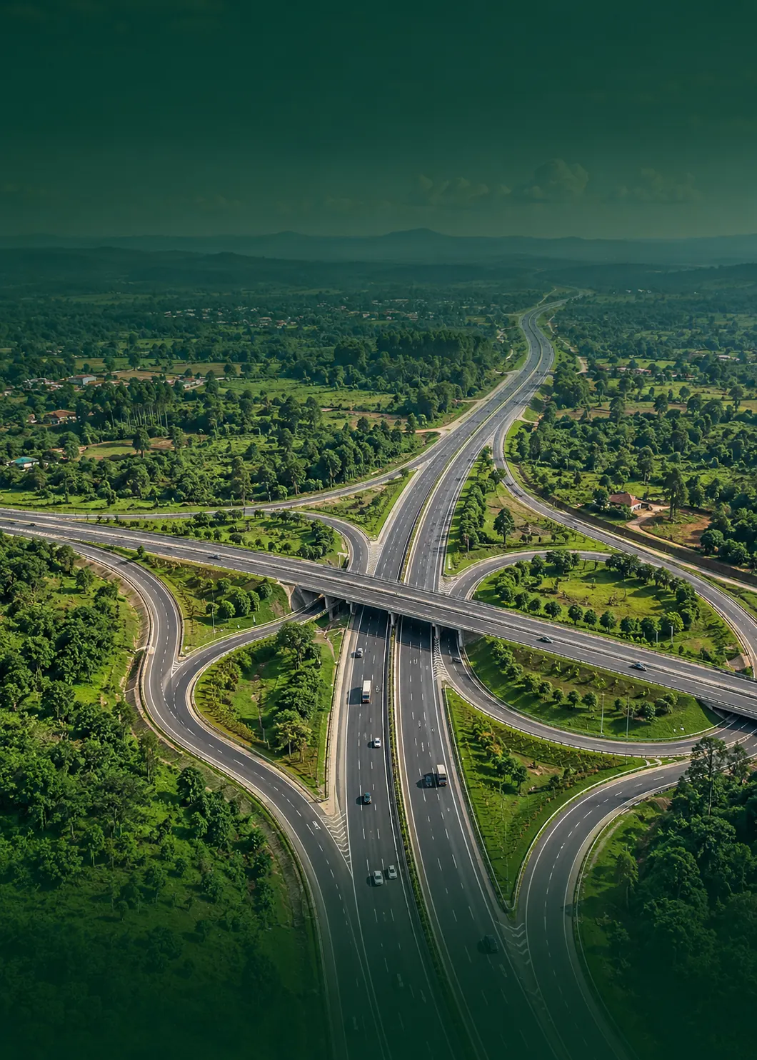 An aerial view of a highway interchange among green farmland